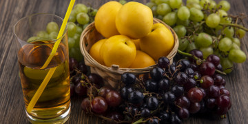 side-view-of-grape-juice-with-drinking-tube-in-glass-and-basket-of-nectacots-with-grapes-around-on-wooden-background.jpg